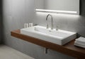 A modern bathroom features a wide rectangular white ceramic sink with sleek, brushed stainless Royalty Free Stock Photo