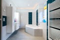 Modern Bathroom - Glossy white and blue tiles - bathtub, sink and floor heating horizontal shot