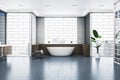 Modern bathroom interior with bathtub, abstract windows and reflections on concrete flooring. Royalty Free Stock Photo