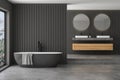 Modern bathroom interior with black wooden walls, double sink on marble Royalty Free Stock Photo