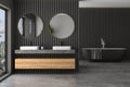 Modern bathroom interior with black wooden walls, double sink on marble Royalty Free Stock Photo