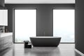 Modern bathroom interior. Concept of contemporary design and spa relaxation. Wood and stone decor elements and big window Royalty Free Stock Photo