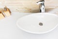 Modern bathroom interior design white ceramic wash basin in oval shape tiled wall with wood texture soap and lotion dispensers
