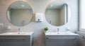 Modern bathroom with two sinks, round mirrors, and dispensers interior Royalty Free Stock Photo
