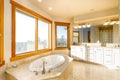Modern bathroom interior featuring neutral beige tiles and ambient light fixtures Royalty Free Stock Photo