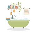 Modern bathroom interior. Foamy bath tub in cozy room. Bathroom shelf with cosmetics and plant