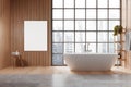 A modern bathroom interior with a large window overlooking the city, featuring a blank poster for mockups and a freestanding Royalty Free Stock Photo