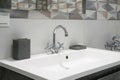 Modern bathroom interior with metal faucet and ceramic white sink. Bath accessories and mirror. Royalty Free Stock Photo