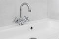 Modern bathroom interior with metal faucet and ceramic white sink. Royalty Free Stock Photo