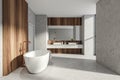 Modern Bathroom interior in new luxury home. Stylish hotel room. Open space area. Concrete wooden walls and floor. Bathtub and Royalty Free Stock Photo