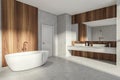 Modern Bathroom interior in new luxury home. Stylish hotel room. Open space area. Concrete wooden walls and floor. Bathtub and Royalty Free Stock Photo