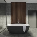 Modern Bathroom interior in new luxury home. Stylish hotel room. Open space area. Concrete wooden walls and floor. Big black