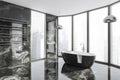 Modern Bathroom interior in new luxury home. Stylish hotel room. Open space area. Marble walls and floor. Black bathtub. Panoramic Royalty Free Stock Photo