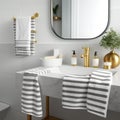 Modern bathroom interior, pile of clean towels and toiletries, white walls, sunny day Royalty Free Stock Photo