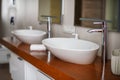 Modern bathroom interior. Modern stylish washbasins with chrome taps. Luxury lifestyle. Wood texture Royalty Free Stock Photo