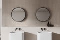 Modern bathroom interior with two round mirrors and double sinks, contemporary design, on a textured wall, concept of luxury and Royalty Free Stock Photo