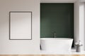 Modern bathroom interior with white ceramic bathtub. Green tile on walls, hardwood flooring. Blank framed poster on wall. Mockup. Royalty Free Stock Photo