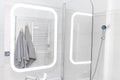 bathroom interior with white wall and illuminated mirror Royalty Free Stock Photo