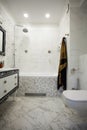 Modern bathroom with marble tiles, luxurius wardrobe and white toilet