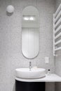 Modern bathroom with oval mirror Royalty Free Stock Photo