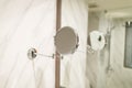 Modern bathroom in the resort hotel. small and big mirrors, marble wall