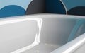 Modern bathroom with a sleek, rectangular bathtub featuring a glossy white finish. Royalty Free Stock Photo