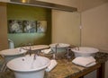 Modern bathroom with two elegant retro white ceramic wash basins Royalty Free Stock Photo