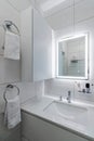 Modern bathroom in white washer and large mirror with backlight Royalty Free Stock Photo