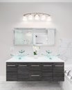 A modern bathroom with a wood cabinet and glass sink. Royalty Free Stock Photo