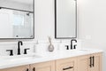 A modern bathroom with a wood cabinet and marble countertop. Royalty Free Stock Photo