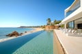 Modern beachfront house with pool on ocean shore.