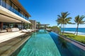 Modern beachfront house with pool on ocean shore.