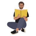 A modern bearded man in glasses reading a book.