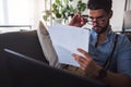 Young businessman working on laptop computer while sitting on sofa at home Royalty Free Stock Photo