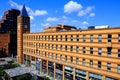 Modern beautiful buildings, skyscrapers, clock tower stand in the center of a big city. Yellow and red brick buildings Royalty Free Stock Photo