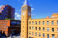 Modern beautiful buildings, skyscrapers, clock tower stand in the center of a big city. Yellow and red brick buildings Royalty Free Stock Photo