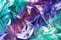 Modern beautiful holographic background of crumpled foil. Trendy 80`s style.