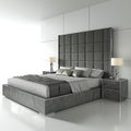 A modern bed with a gray headboard and a white wall Royalty Free Stock Photo