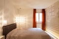 Modern bedroom with bed covered with a quilt