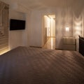 Modern bedroom with bed covered with a quilt