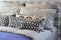 Modern bedroom with black and white pillows on bed and decorative alarm clock Royalty Free Stock Photo