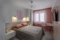 A modern bedroom in blue, pink and white colors with muffled lighting. Real photo Royalty Free Stock Photo