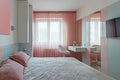 A modern bedroom in blue, pink and white colors with muffled lighting. Real photo Royalty Free Stock Photo