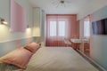 A modern bedroom in blue, pink and white colors with muffled lighting. Real photo Royalty Free Stock Photo