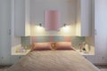 A modern bedroom in blue, pink and white colors with muffled lighting. Real photo Royalty Free Stock Photo