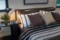 Modern bedroom with brown, black and white striped pillows Royalty Free Stock Photo