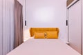 Modern bedroom with a comfortable bed, warm upholstered headboard, and ample storage from built-in sliding wardrobes Royalty Free Stock Photo