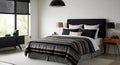 Modern Bedroom with Striped Bedding and Black Headboard Royalty Free Stock Photo