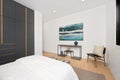 the modern bedroom has black cabinets and wooden floors, along with a painting above the