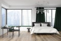 Modern bedroom interior with bed and workplace, panoramic window with city view